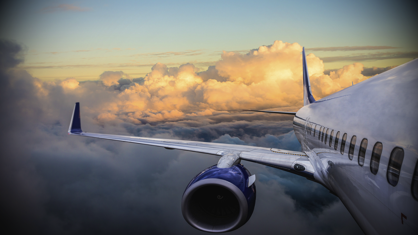 Aircraft flying above clouds